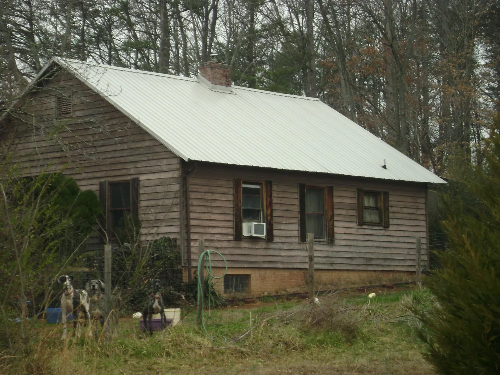 White metal roof on an old wood sided farmhouse, from a Metal Roof Installation job in Cumberland
